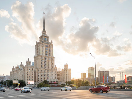 MOSCOW, RUSSIA - August 22, 2021. Cars move pass hotel Ukraine. Famous skyscraper at summer sunset.のeditorial素材