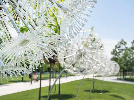 KRASNODAR, RUSSIA - June 01, 2021. People walks on alley in modern public park Krasnodar. Futuristic lanterns in shape of dandelions.のeditorial素材