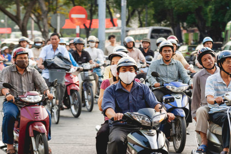 HO CHI MINH, VIETNAM - March 28, 2009. Local people drive motorbikes on street in historic center of...