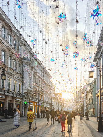 MOSCOW, RUSSIA - November 02, 2019. Local people and tourists walk down famous Nikolskaya street, decorated with light bulbs.のeditorial素材