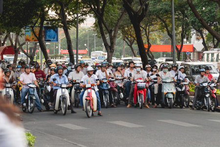 HO CHI MINH, VIETNAM - March 28, 2009. Local people drive motorbikes on street in historic center of Ho chi minh city.のeditorial素材