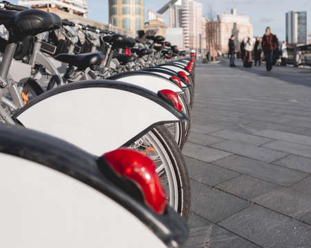 Bicycles for rent parked on street. Urban road and row of eco-friendly vehicles for tourists. Moscow, Russia.の写真素材