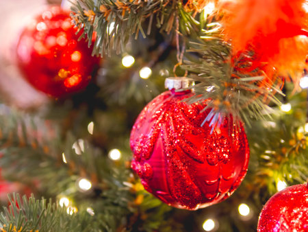 Christmas tree with shiny decorations. Fir tree decorated with light bulbs and red balls for New...