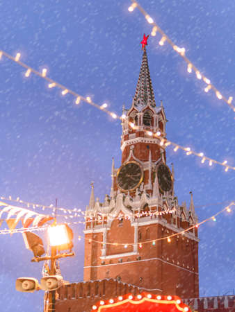 Spasskaya tower of Kremlin, view through light bulbs. Traditional Christmas fair on Red square in Moscow. Russia.の写真素材