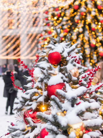 Christmas tree with colorful outdoor decorations. Fir tree decorated with light bulbs for New Year celebration. Moscow, Russia.の写真素材