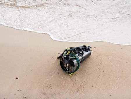 Diver's equipment on sea coast. Rubber flippers and diver propulsion vehicle. Black underwater...
