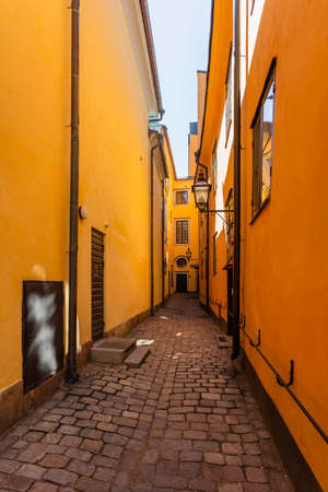 Narrow streets in historic part of town. Old fashioned buildings in Gamla stan. Stockholm, Sweden.の写真素材