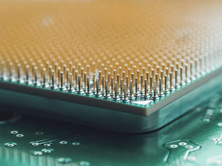 Macro photo of hard disk controller board and Central Computer Processor. CPU on green background. IT detail in computer. Technological detail of personal computer.の写真素材