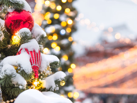 Christmas tree with colorful outdoor decorations. Fir tree decorated with light bulbs for New Year celebration. Moscow, Russia.