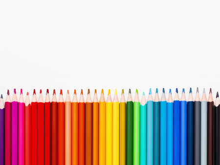 Vertical row of colorful pencils on white background. School supplies in colors of rainbow. Kid's stationery with copy space. Back to school backdrop.の写真素材