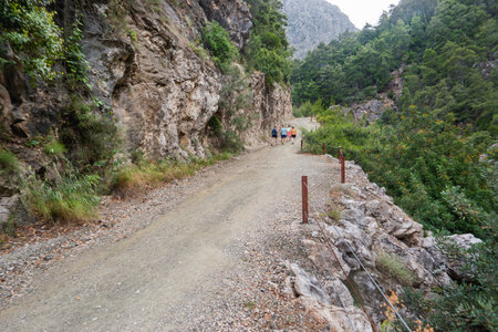 Tourists walk along the river in Goynuk Canyon. Aerial view on mountain slopes in Beydaglari Coastal National Park. Turkey.の写真素材