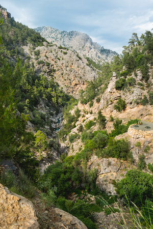 Tourists walk along the river in Goynuk Canyon. Aerial view on mountain slopes in Beydaglari Coastal National Park. Turkey.の写真素材