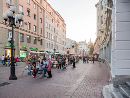 MOSCOW, RUSSIA - October 16, 2022. Local people and tourists walk on famous Arbat street. Autumn sunset over historical center of capital.のeditorial素材