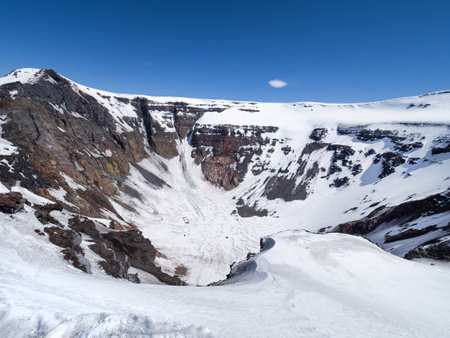 Caldera of Flatsky Tolbachik stratovolcano. Mountain peaks covered with snow in good weather with clear sky. Hiking in Kamchatka peninsula, Russia.の写真素材