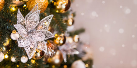 Christmas tree with shiny decorations. Fir tree decorated with light bulbs, lace flower and golden balls for New Year celebration.の写真素材