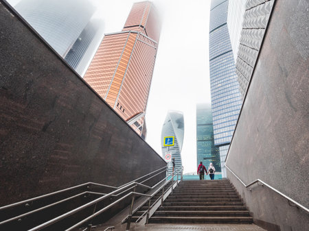 MOSCOW, RUSSIA - November 09, 2022. View on skyscrapers of Moscow-city International Business Center and couple with holding hands from underground pedestrian crossing.のeditorial素材