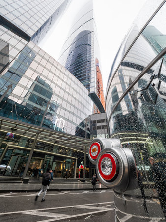 MOSCOW, RUSSIA - November 09, 2022. People on street in Moscow-city International Business Center. Raindrops on metal surfaces and glass walls of modern skyscrapers.のeditorial素材