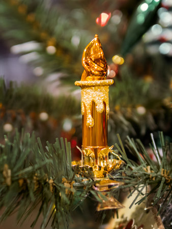Christmas tree with shiny vintage decorations. Fir tree decorated with light bulbs, retro electric candle with spangles for New Year celebration.の写真素材