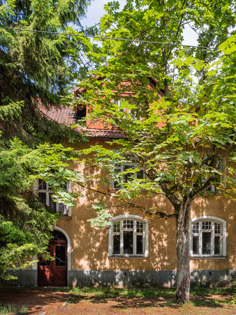 Old house in Svetlogorsk. Old fashioned building behind trees. Svetlogorsk, Russia.の写真素材