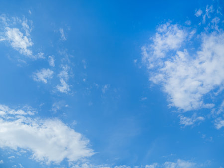 Bottom view on blue sky with fluffy clouds. Sunny day with good weather. natural background.の写真素材