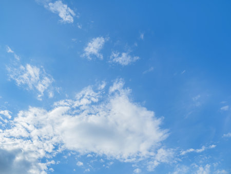 Bottom view on blue sky with fluffy clouds. Sunny day with good weather. natural background.の写真素材