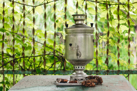 Vintage samovar - old traditional Russian kettle. Metal retro appliance to boil water. Pine cones...