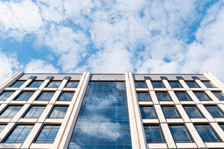 Bottom view on building of business center on blue sky background. modern architecture.のeditorial素材