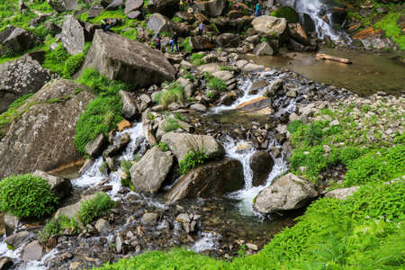 JOGNI FALLS, MANALI, INDIA - JULY 14, 2018 : People click each others' photographs in this natural geometric camouflage. The rocks appear small, but are way too bigのeditorial素材