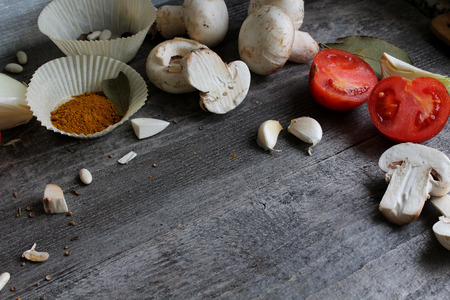 Grey wooden table with vegetables, onions, mushrooms, peppers, asparagus and spices. Process of cooking. Concept food. cooking.の写真素材