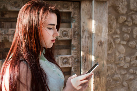 pretty young girl looking at the phone