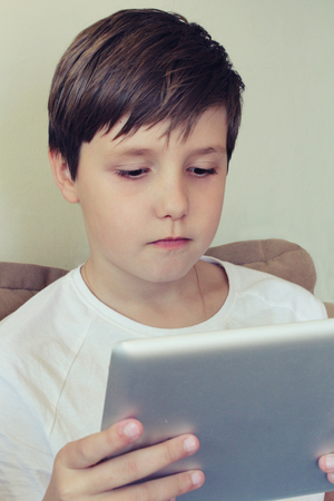 boy hold tablet in the handsの写真素材