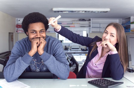 young pretty woman and man  in the officeの写真素材