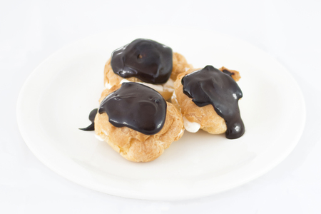 Delicious fresh profiterol platter isolated on white backgroundの写真素材