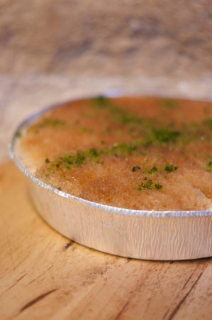 Traditional Cypriot dessert ekmek kadayifi on wooden table