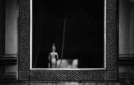 Buddha statue in the windowの写真素材