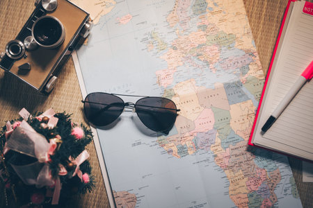 The adventure with the map and the camera, note on a wooden table. Top view. Travel concepts.