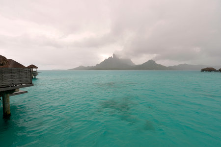 Storm shower on the horizon of a motu in Bora Boraのeditorial素材