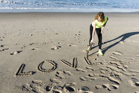The word love written on the beach sandの写真素材
