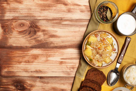 Sauerkraut soup on a wooden board.Photographed overhead on rustic wood.Copy space.の写真素材