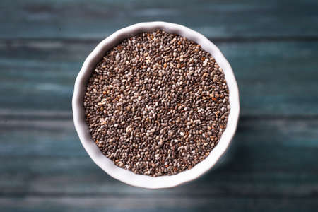 Quinoa grain in a bowl on the green wooden background.の写真素材