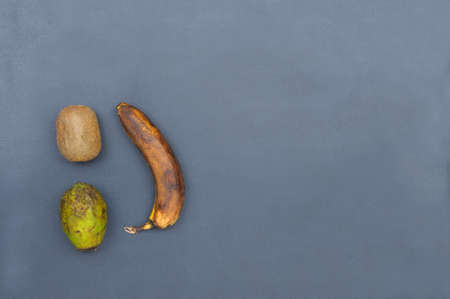 Rotten food on grey background , top view.Fruit and vegetable waste.の写真素材
