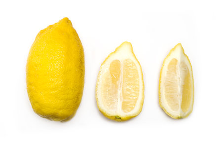 Image of  homegrown ugly lemons. One whole fruit, one half, one quarter.Concept of different...