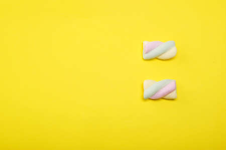 Creative layout made with sweet  swirl  marshmallow on pastel background. Macro concept. Minimalism. Flat lay with copy space.の写真素材