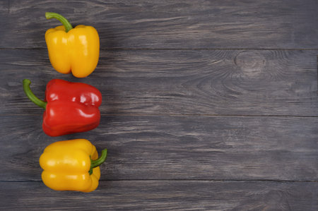 Different colour organic  peppers on wooden background. Top view flat lay, group objects . Useful...