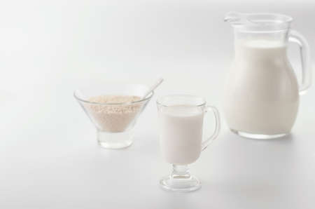 Homemade non diary sesame milk in the glass cup  andin the pitcher on light  background. Selective focus. Raw food diet. Vegan concept.Image with copy space,horizontal.の写真素材