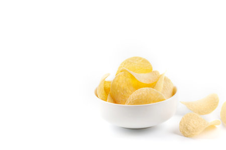 Tasty  potato chips  the white pile and some on the background. Selective focus. Healthcare concept....
