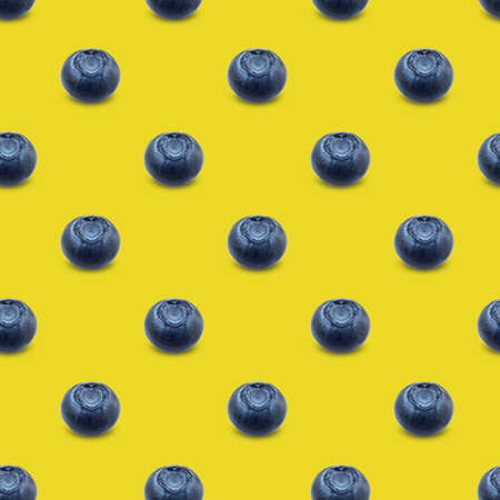 Seamless pattern with blueberries on a yellow background. Modern style isometric concept.Flat lay, top view.の写真素材