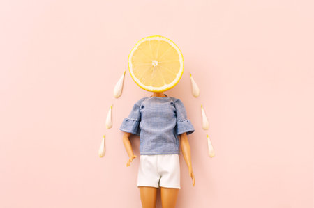 Girl doll with lemon head. Creative minimal fashion concept.