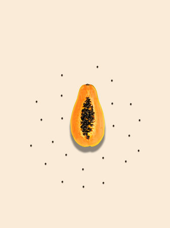 Creative pattern with summer tropical papaya fruitÂ  and seeds over pastel sand background....