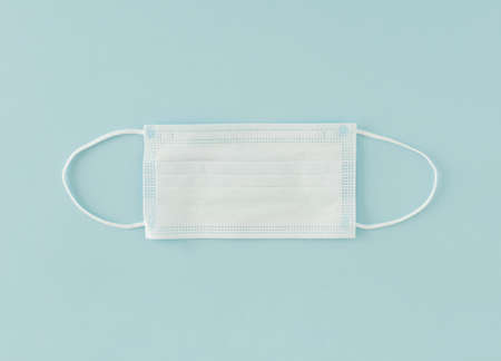Medical mask on a blue background from CoronaVirus. Safety mask, dust protection respiratory, and a medical respiratory mask.の写真素材